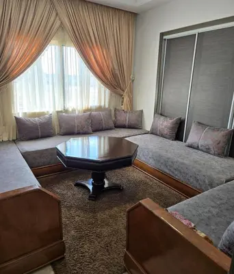 a living room with a couch and a coffee table at 2 Bedroom Apartment in Mohammedia