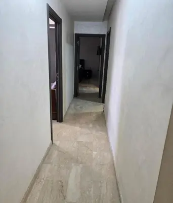 an empty hallway with a hallway leading into a room at 2 Bedroom Apartment in Mohammedia