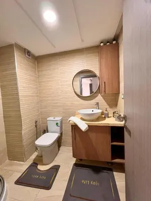 a bathroom with a toilet and a sink and a mirror at Suite Horizon in Mohammedia