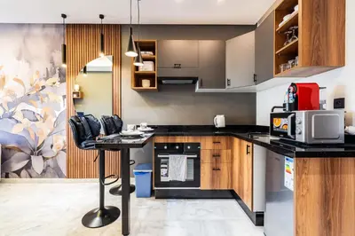 a kitchen with a table and a microwave at Résidence Cerezo in Maarif