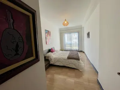 a bedroom with a bed and a painting on the wall at Ocean Symphony in Îlot de Skhirat