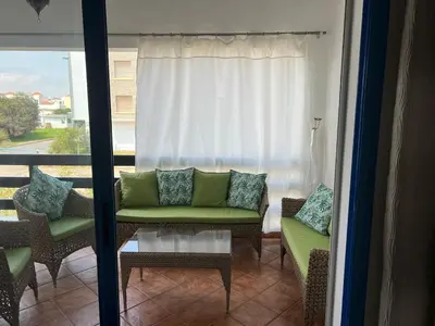 a living room with a couch and chairs on a balcony at Ocean Symphony in Îlot de Skhirat