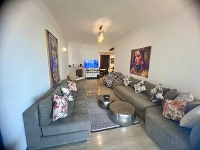 a living room with two couches and a table at Ocean Symphony in Îlot de Skhirat
