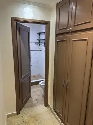 a bathroom with a toilet and a closet with a door at Chic house living in Casablanca