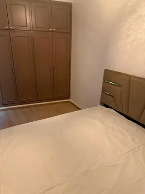 a bedroom with a bed and some brown cabinets at Chic house living in Casablanca