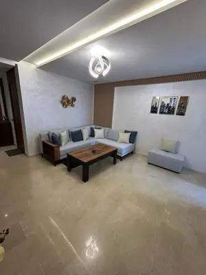 a living room with a couch and a table at Studio au Parc Mohammedia in Mohammedia