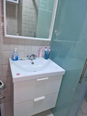a bathroom with a sink and a shower at Votre Appartement neuf meublé vous attend in Skhirat