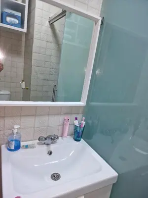 a bathroom sink with a mirror and a shower at Votre Appartement neuf meublé vous attend in Skhirat