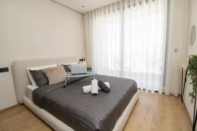 a bedroom with a bed with a laptop on it at Luxurious studio Great location in Casablanca