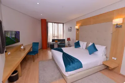 a hotel room with a large bed and a desk at Le 135 appart hotel in Casablanca
