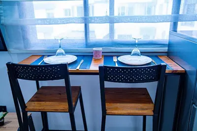 a table with two chairs and two wine glasses at R102-3-4 Amazing apartments in Belvedere with Breathtaking Ocean and Street Views in Casablanca