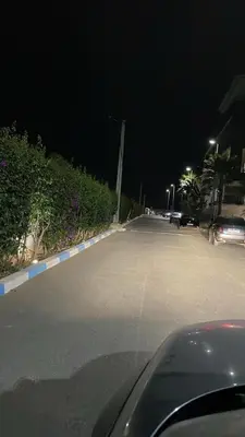 a car driving down a street at night at Cosy apartment in Bouznika in Bouznika