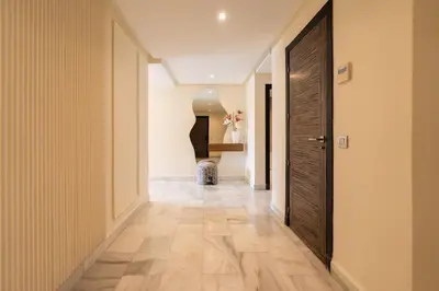 a hallway with a wooden door in a house at Le yacht apartment II Oceanfront residence 2 BR 2 BA in Casablanca