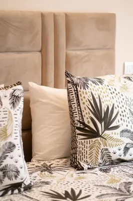 a bed with pillows on top of it at Le yacht palace beachfront residence 2 BR 2 BA in Casablanca