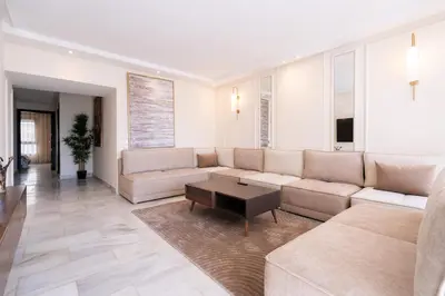 a living room with a couch and a table at Le yacht palace beachfront residence 2 BR 2 BA in Casablanca