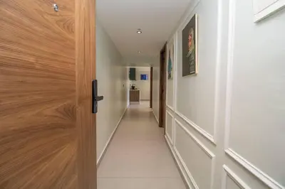 a hallway with a wooden door with a hallway leading into a room at Private terrasse and spa Studio Sahara in Casablanca in Casablanca