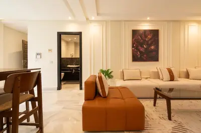 a living room with a couch and a table at Le yacht luxury apartment 2BR 2BA corniche with parking in Casablanca