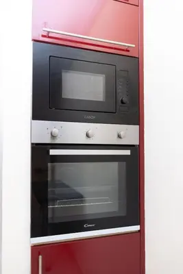 a microwave oven sitting on top of a red wall at Luxury 2 BR 2 BA Alsace Lorraine downtown in Casablanca