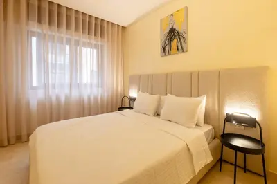 a bedroom with a white bed and a window at Luxury 2 BR 2 BA Alsace Lorraine downtown in Casablanca