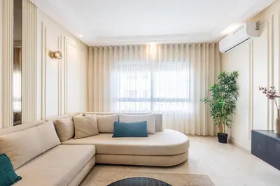 a living room with a couch and a large window at cozy living, Chic 3BR appartement with parking! in Casablanca