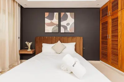a bedroom with a white bed with two pillows on it at 3BR Modern Stay in Heart of Rabat in Rabat
