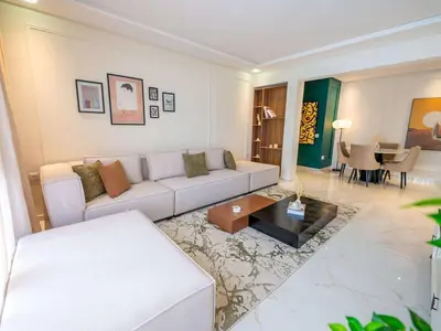 a living room with a couch and a table at Modern & Central 2BR Stay in Rabat in Rabat