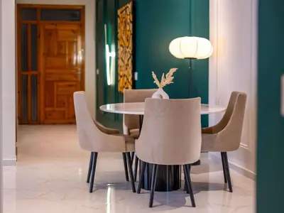 a dining room with a table and chairs at Modern & Central 2BR Stay in Rabat in Rabat