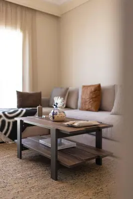 a living room with a couch and a coffee table at Luxury 2BR Apartment City Center with Parking in Casablanca