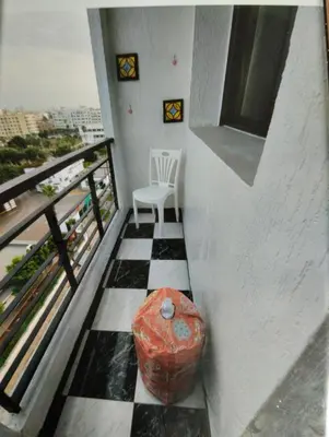 a balcony with a table and a chair at Spacious with Great Location in Casablanca