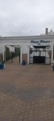 a large white building with an open doorway at Vue Mer & Sérénité, Appartement Chic avec Piscine à Dar Bouazza in Tamaris