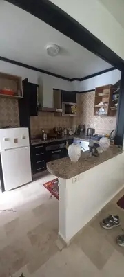 a kitchen with a counter top in a room at Vue Mer & Sérénité, Appartement Chic avec Piscine à Dar Bouazza in Tamaris