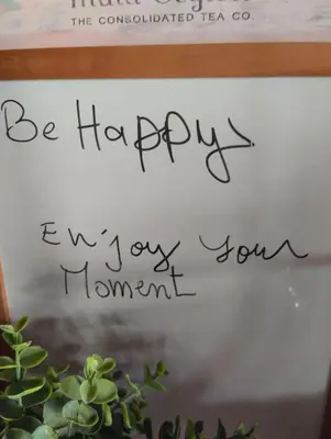 a sign that says be happy next to a plant at Rosy Bliss in Casablanca
