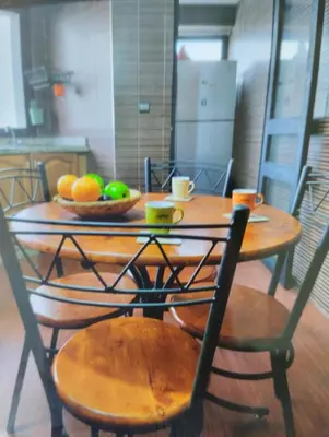 a wooden table with a bowl of fruit on it at Rosy Bliss in Casablanca
