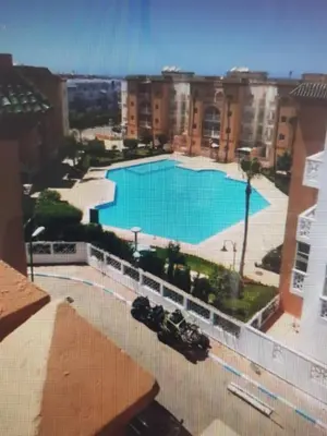 a view of a large swimming pool from a building at ossama in Mansouria