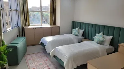 a room with two beds and a couch and windows at Studio Tetouan in Deroua