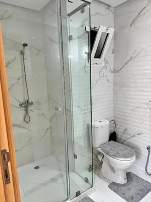 a bathroom with a shower and a toilet at Appartement familial vue piscine in Temara