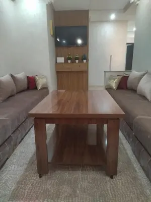 a living room with a wooden table and a couch at Relaxation stay in Casablanca
