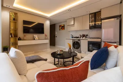 a living room with a white couch and a table at Small nest in a good location, quiet in Casablanca