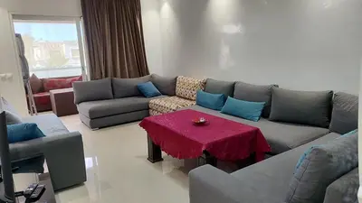 a living room with a couch and a table at Résidence balnéaire casablanca in Dar el Maïzi