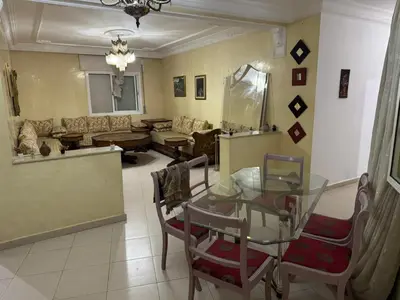 a living room with a glass table and chairs at Martil in Anfa-Supérieur