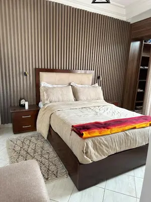 a bedroom with a bed with a colorful blanket on it at Apartment in Casablanca Maarif in Casablanca
