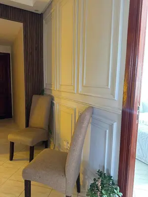 two chairs in a room with yellow walls at Apartment in Casablanca Maarif in Casablanca