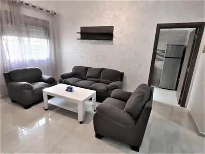 a living room with two couches and a table at Beau appartement pour votre séjour a Casablanca Bouskoura in Bouskoura