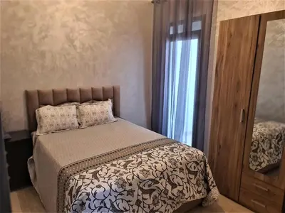 a bedroom with a bed and a window at Beau appartement pour votre séjour a Casablanca Bouskoura in Bouskoura