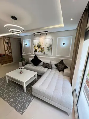 a living room with a couch and a table at M4 Spacious Appartment in Exclusive Residence by the Sea in Rabat