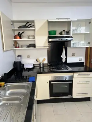a kitchen with a stove and a sink at M4 Spacious Appartment in Exclusive Residence by the Sea in Rabat