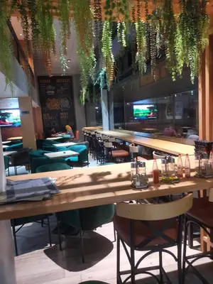 a restaurant with tables and chairs and a bar at CASABLANCA BORD dE MER A 200 m DE LA PLAGE Appartement Haut de gamme 2 Chambres avec 2 Salles de bain Piscine Salle de Sport plage in Casablanca