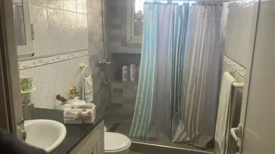 a bathroom with a shower curtain and a sink at 2 Bedroom APT Near downtown - Perfect Location in Casablanca