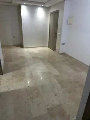 an empty room with a tile floor and a door at Superb appartement moyen standing au cœur de Aïn Sebàa in Casablanca