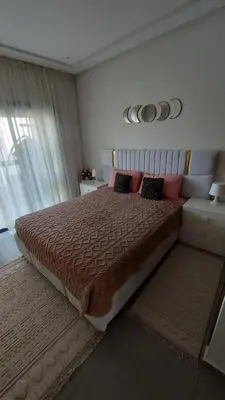 a bedroom with a large bed with pillows on it at Sublime appartement à MANSOURIA in Mansouria